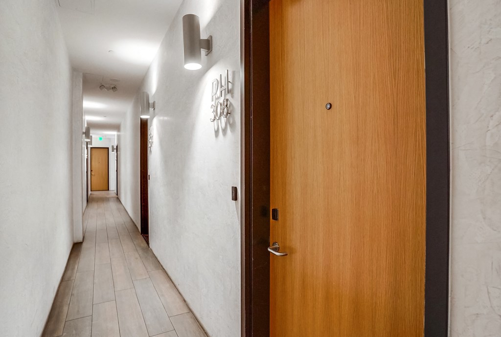 an open door in a corridor of a hotel