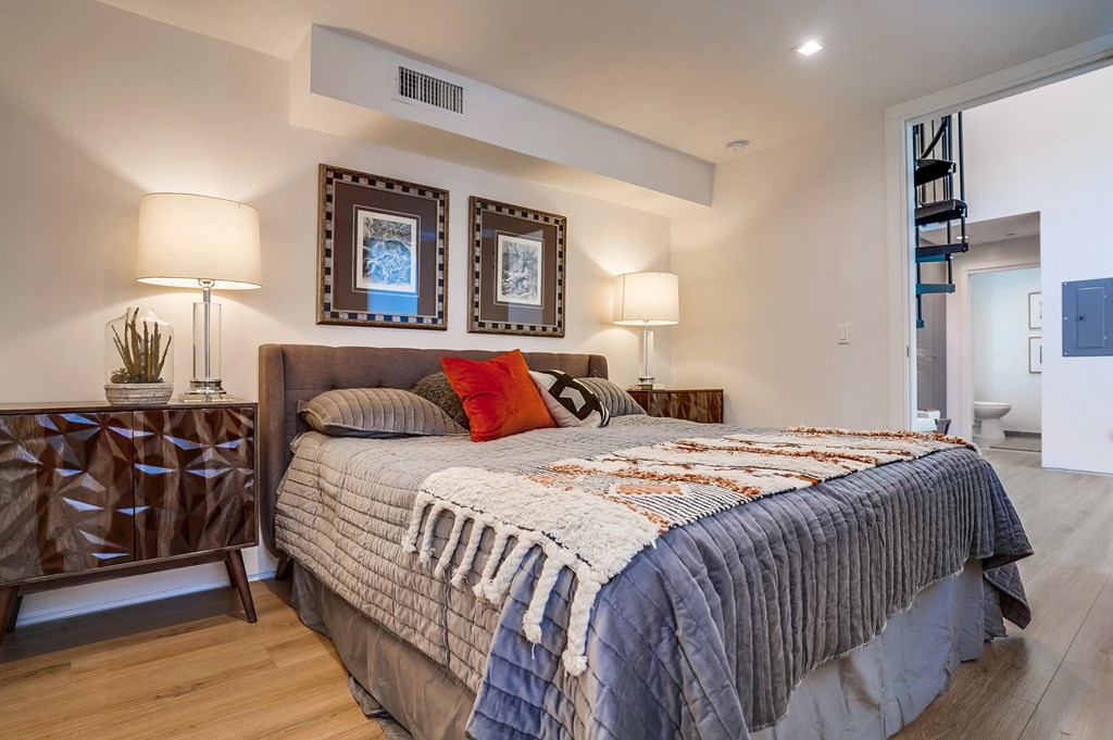 a bedroom with a bed and two lamps