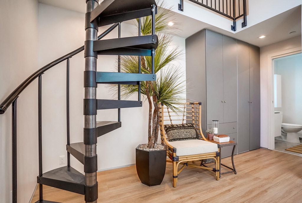 a spiral staircase leads to the second floor