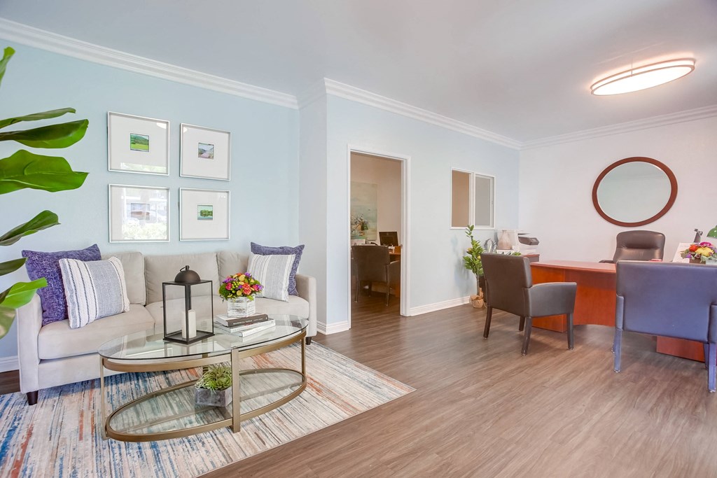 a living room with a couch and a glass coffee table