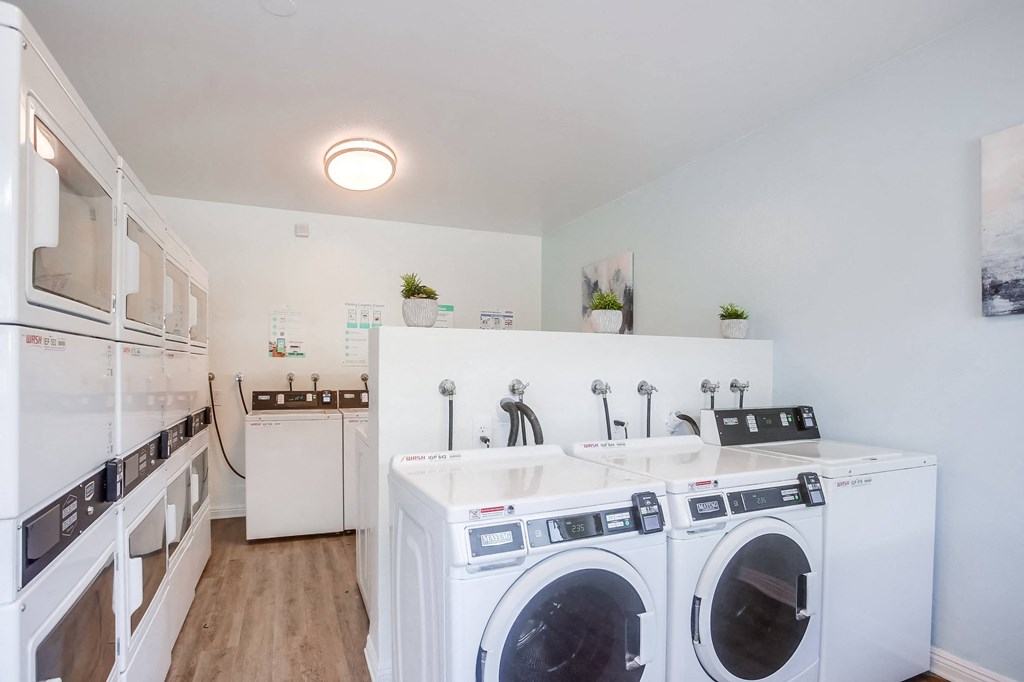 a washer and dryer in a laundry room with a sink and a counter