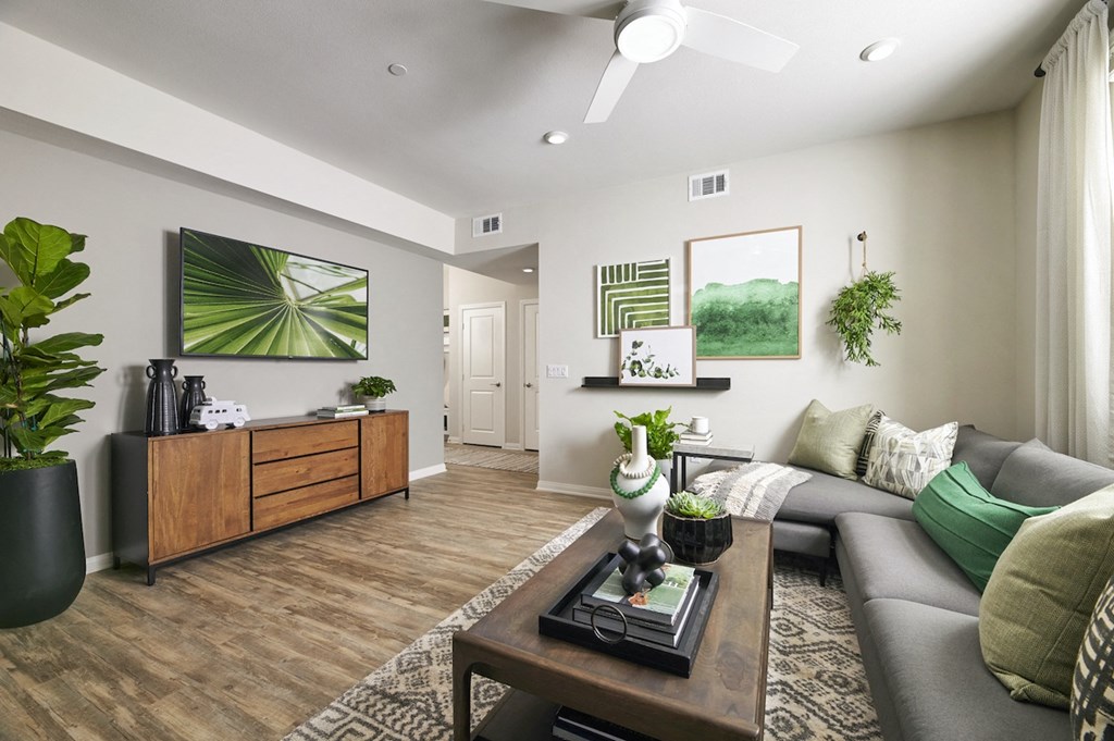 Dog-Friendly Apartments In Riverside, CA - Lincoln Village - Living Room With Wood Style Flooring, Stylish Decor, And Large Window With Curtains