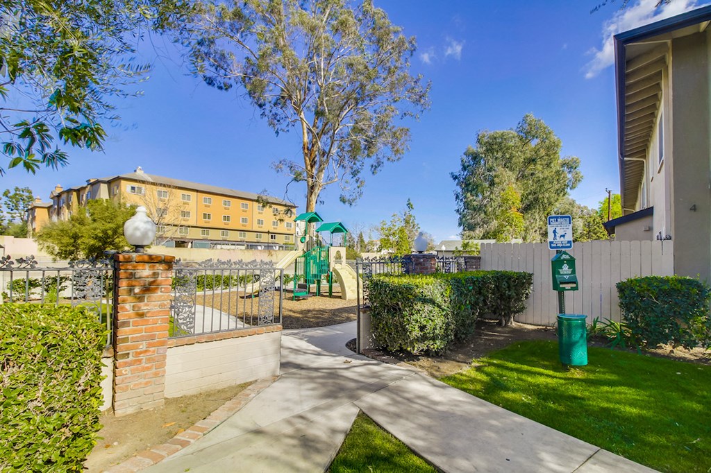 A sunny day in a residential area with a clear blue sky.