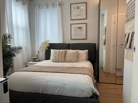a bedroom with a large bed in front of a window