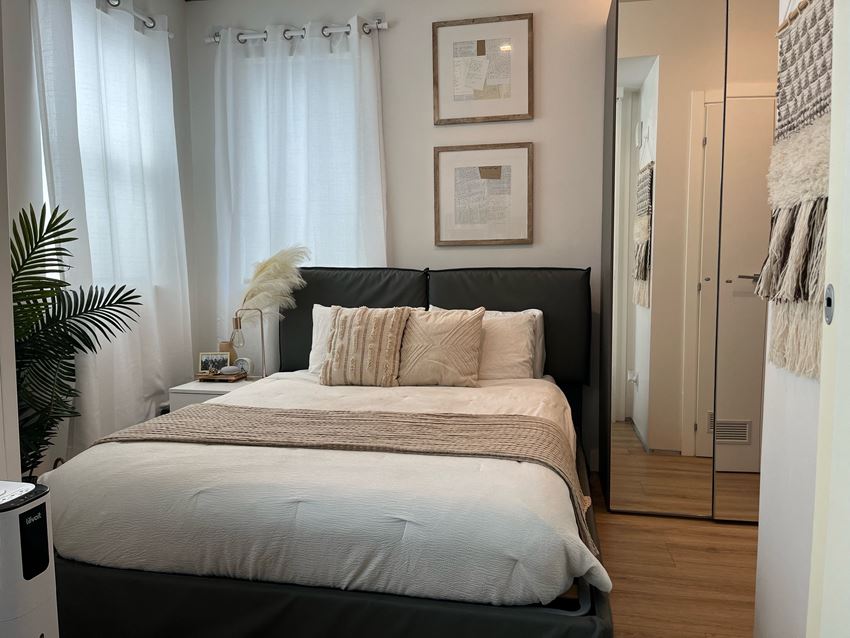 a bedroom with a large bed in front of a window - Photo Gallery