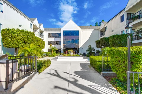 the courtyard of a condo building with a fountain in the center