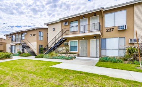 Apartment building number 237 with a staircase leading to the second floor.