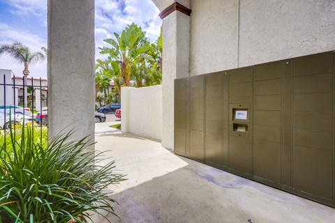A parking garage with a grey wall and a brown door.