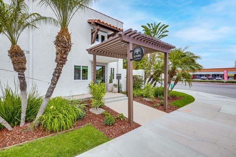 A white building with a brown awning and a sign that says "Bella Vista".