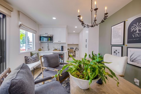 A living room with a grey couch and a wooden table.