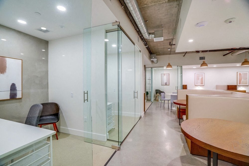 a conference room with glass walls and a table and chairs