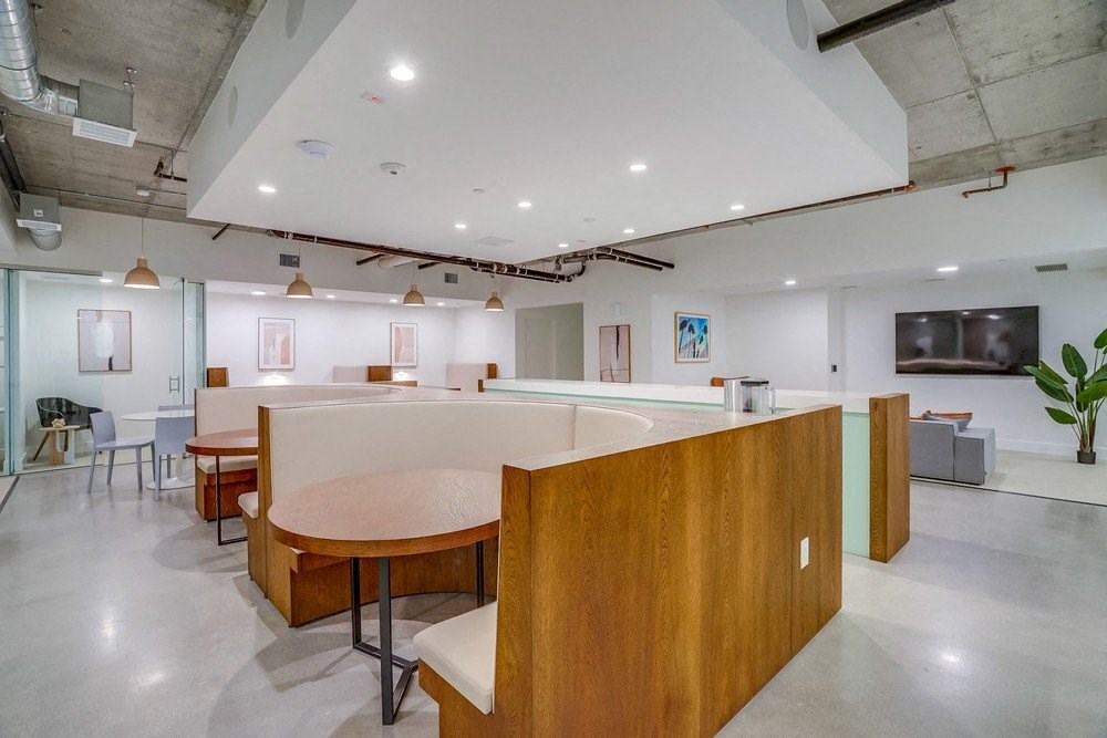 the interior of a large room with a large table and chairs and a seating area