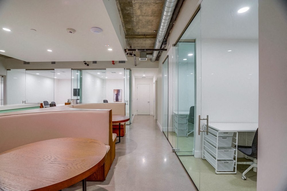 a large room with a table and chairs and a glass door