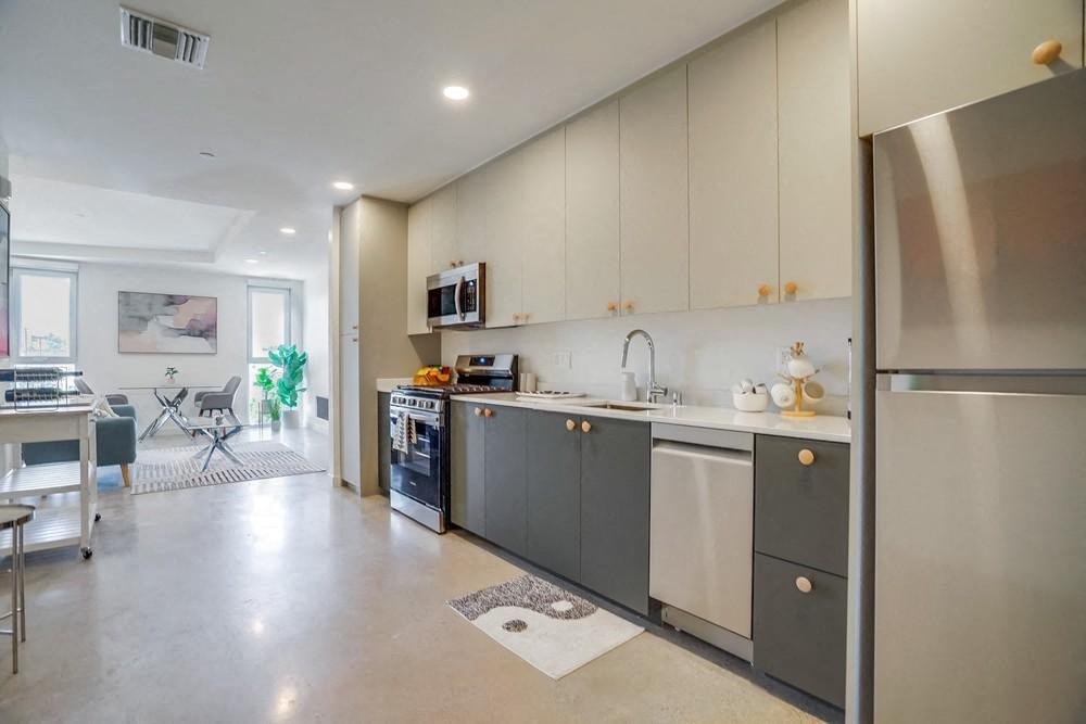 a kitchen with a sink and a refrigerator