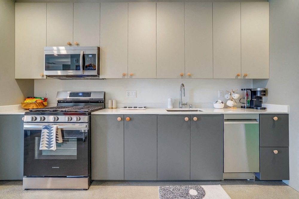 a kitchen with stainless steel appliances and white cabinets