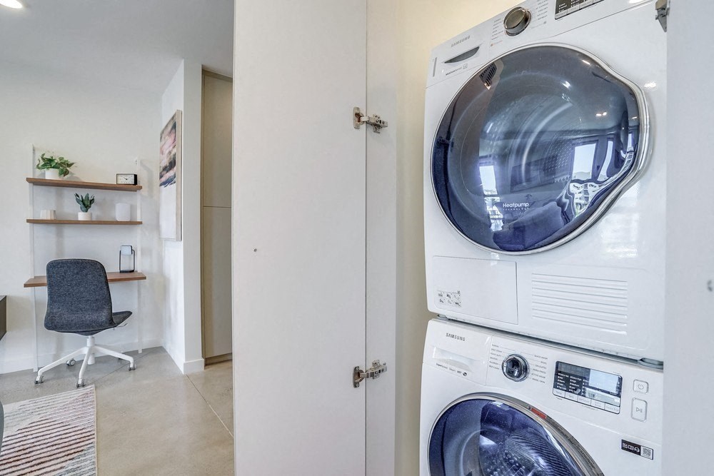 a washer and dryer in a laundry room next to a closet