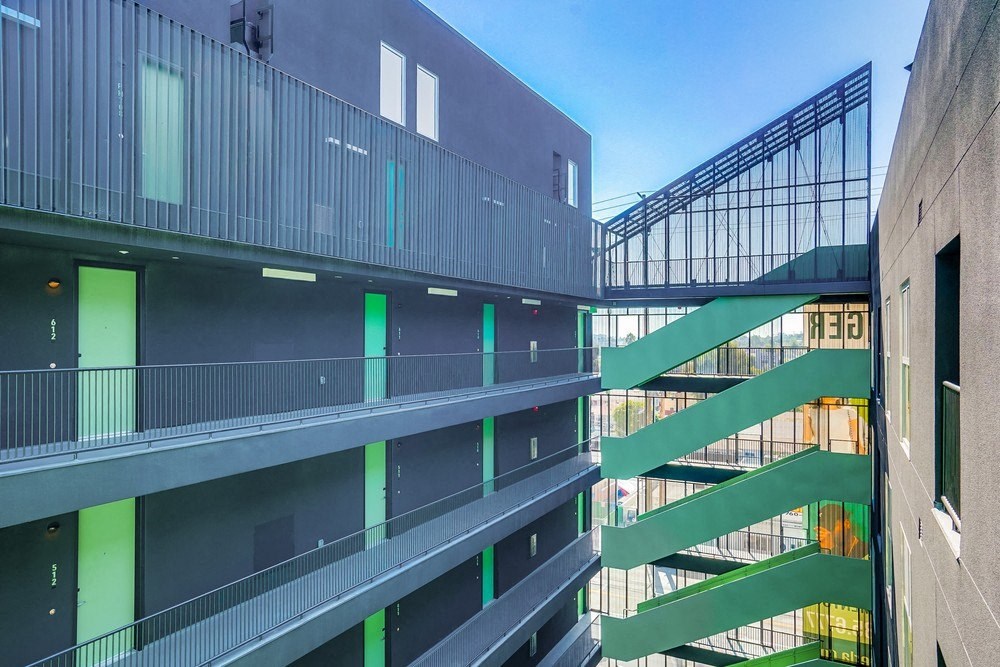 a view of a building with green balconies