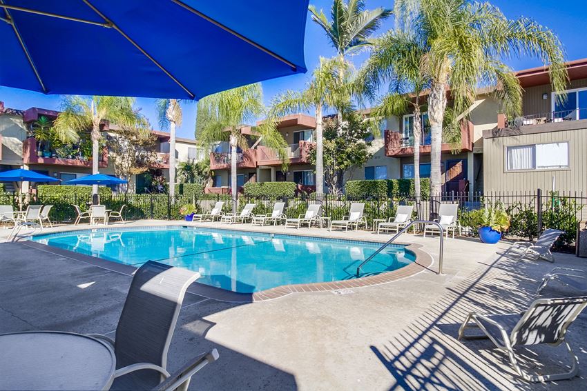 a resort style swimming pool with chaise lounge chairs and umbrellas - Photo Gallery