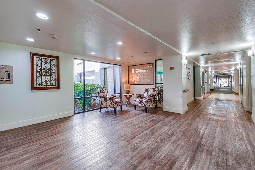 a resident clubhouse with hardwood flooring and large windows