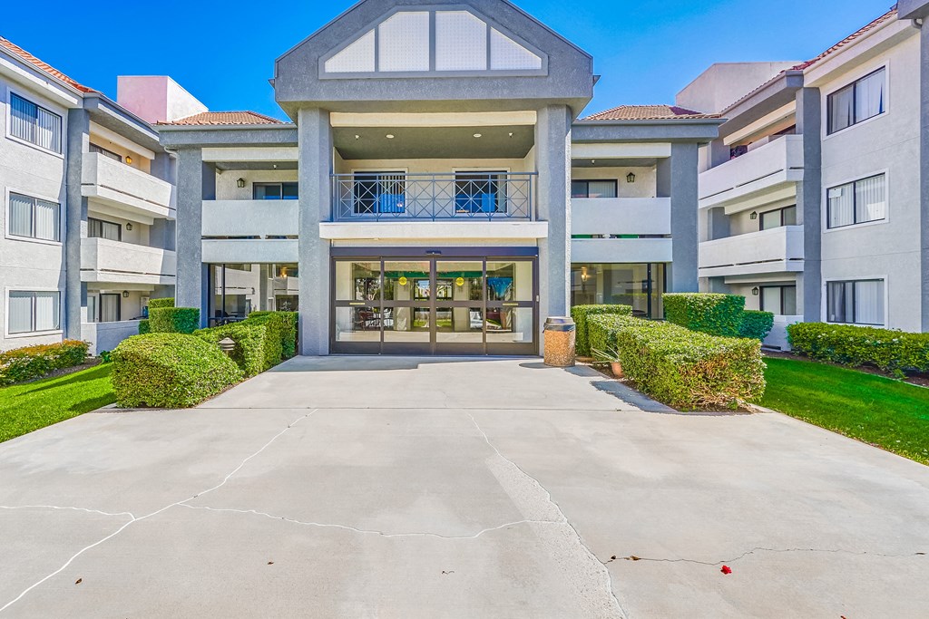 a large white building with a large driveway in front of it