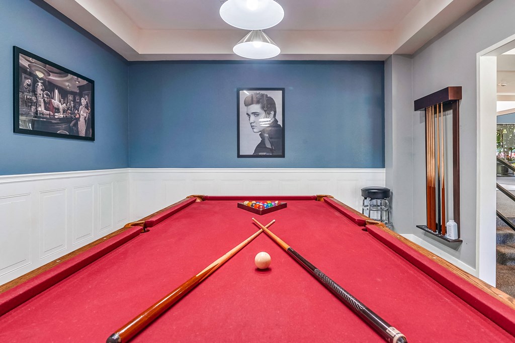 a red pool table in a blue room