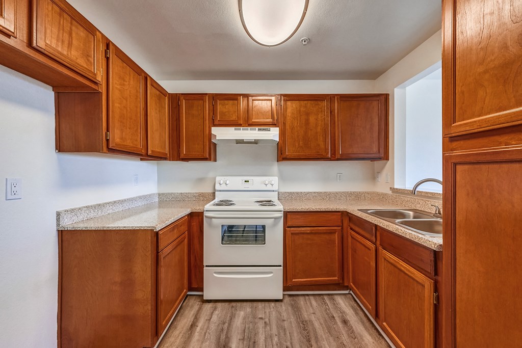 a kitchen with wood cabinets and white appliances