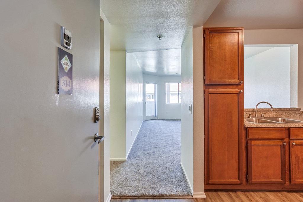 a view from the living room into the kitchen and dining room