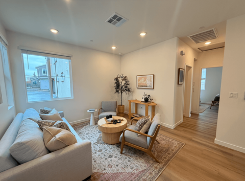 A living room with a couch, chair, and coffee table.
