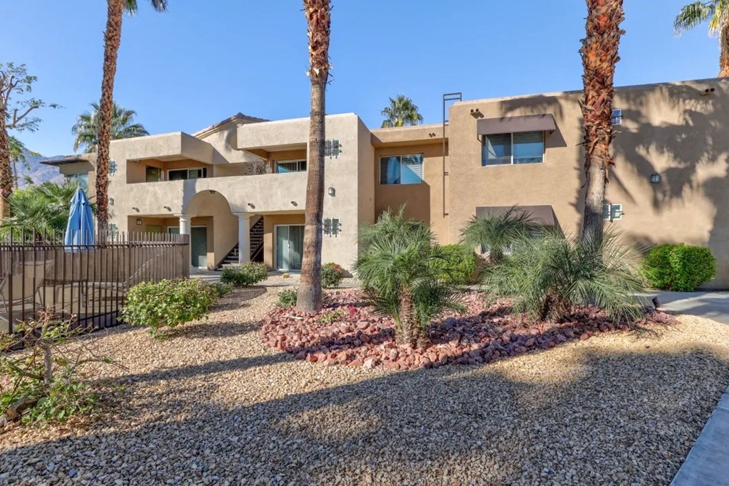 a building with palm trees in front of it