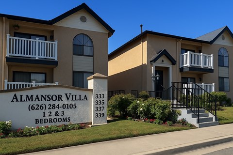 The image shows a building with the name Almansor Villa and a sign in front of it.