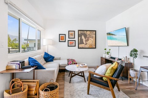 A living room with a couch, chair, and a television.