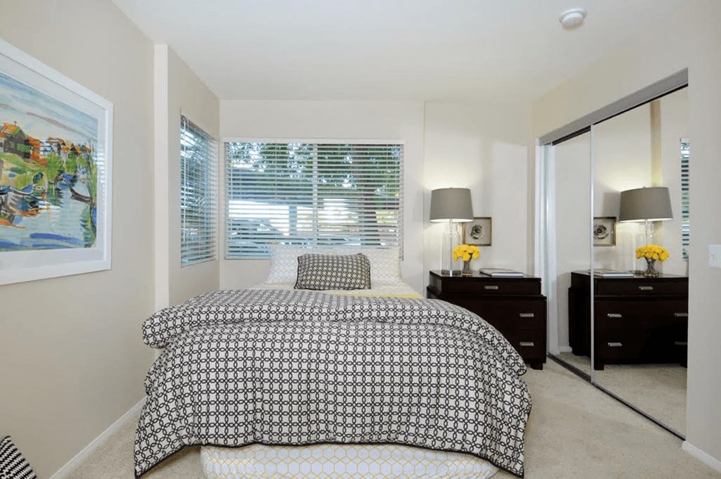 a bedroom with a bed and a window