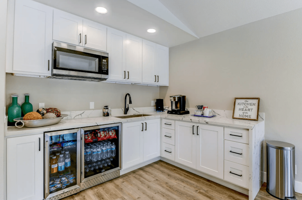 a kitchen with white cabinets and white countertops