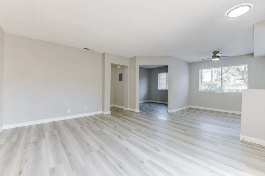 an empty living room with a large window