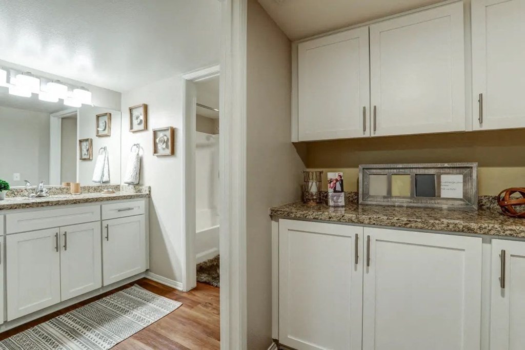 a kitchen with white cabinets and a counter top