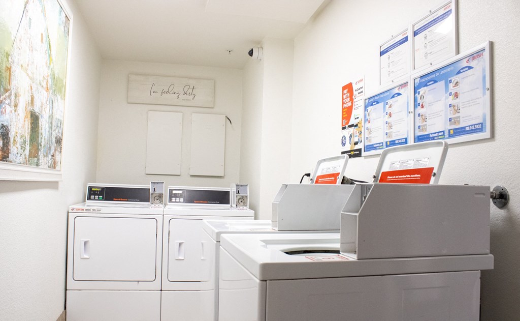 Laundry Care Center with washer and dryers 
at Imperial Apartments in Santa Ana, CA.