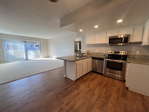 A kitchen with a stove top oven and microwave.
