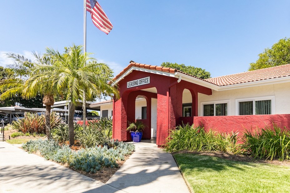 a red and white building with an american flag in front of it