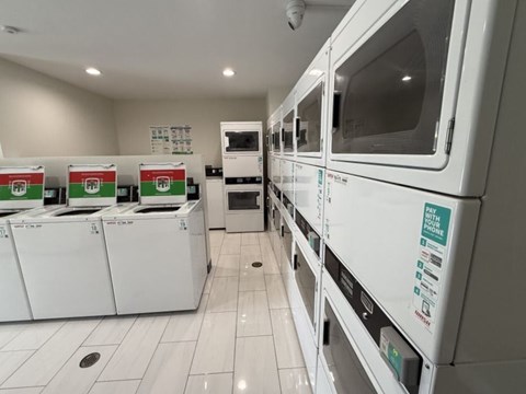 A row of white ovens are lined up in a room.
