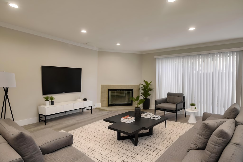 A modern living room with a fireplace and a television.