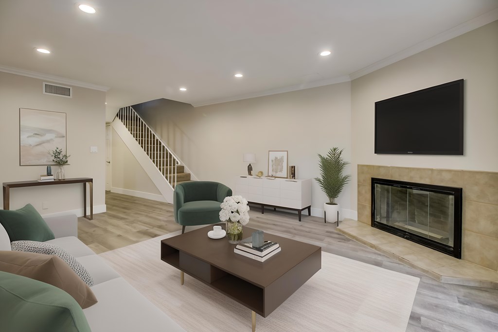 A living room with a fireplace and a television.