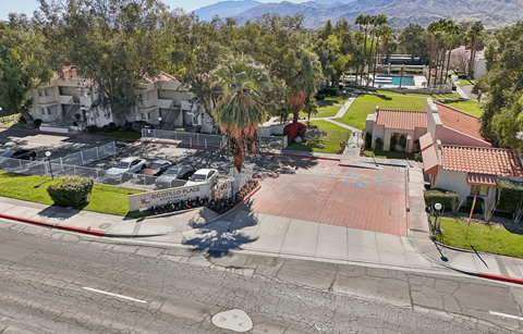 A street view of a residential area with houses and a swimming pool.