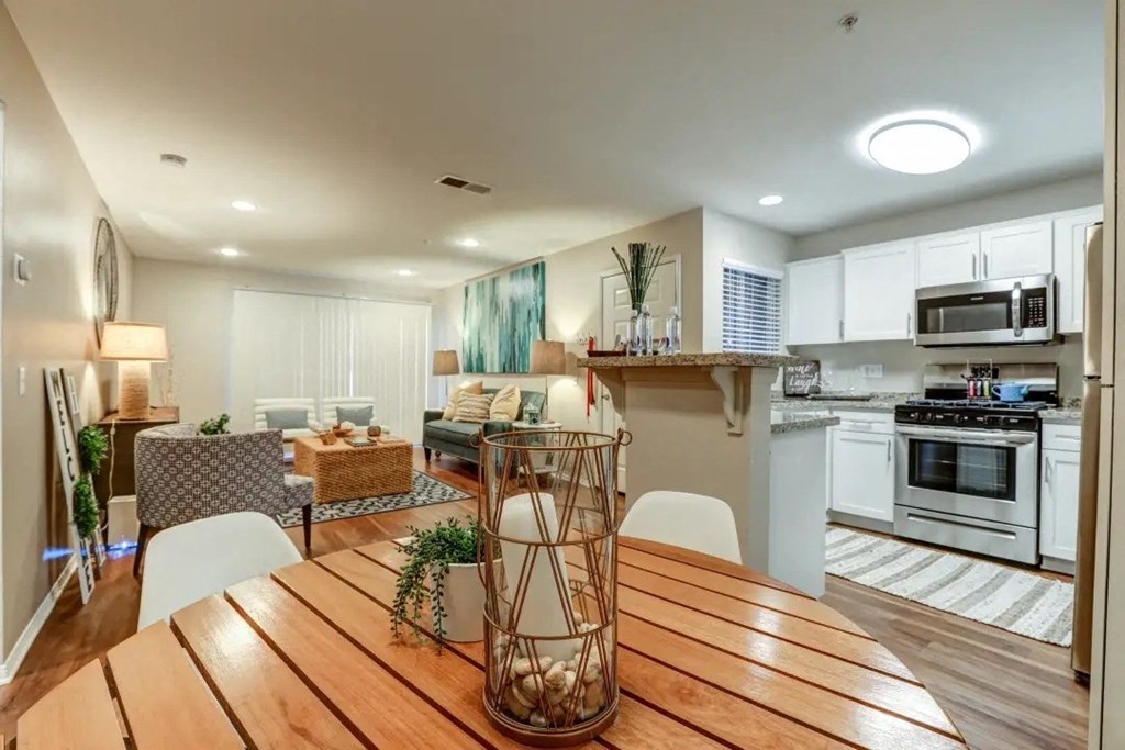 a kitchen and dining room with a wooden table