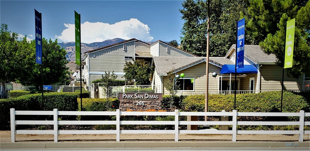 a white fence in front of a house