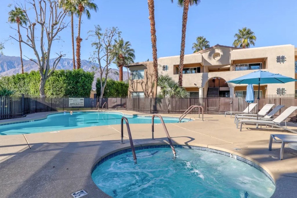 our resort style swimming pool is surrounded by palm trees and our building