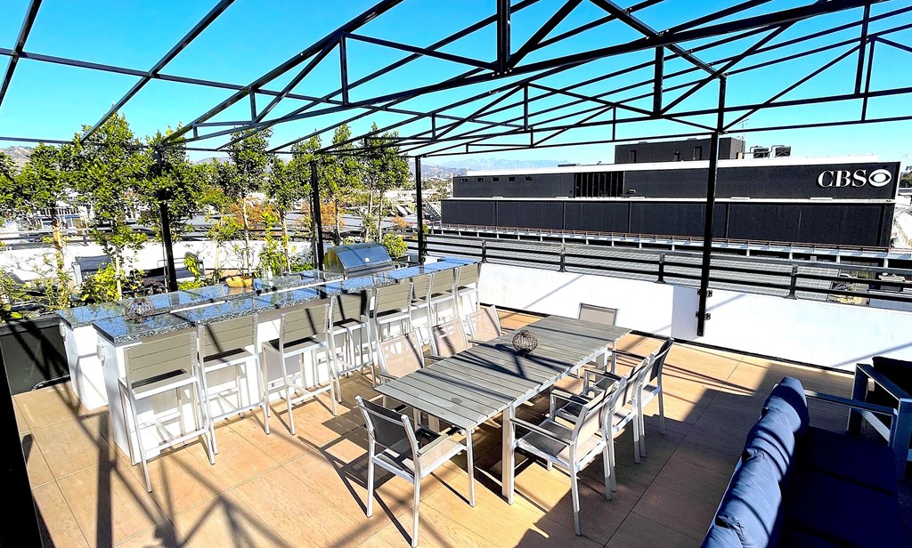 an outdoor patio with tables and chairs on a sunny day