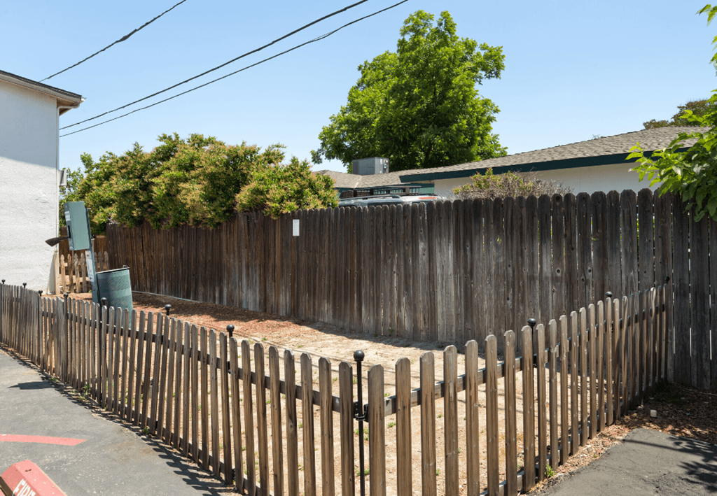 a wooden fence in front of a house