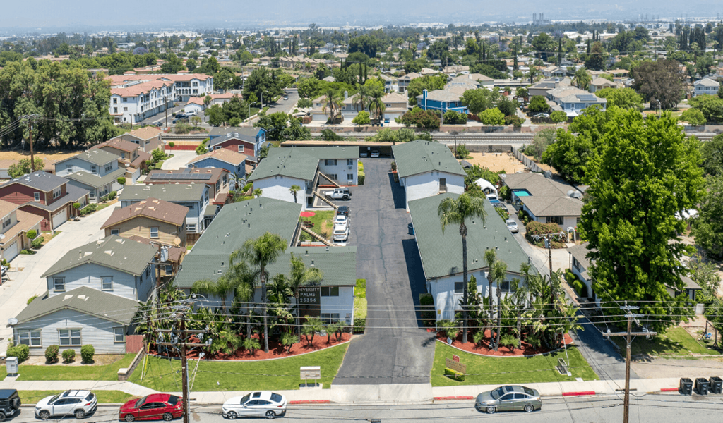 an aerial view of a neighborhood of houses with cars parked