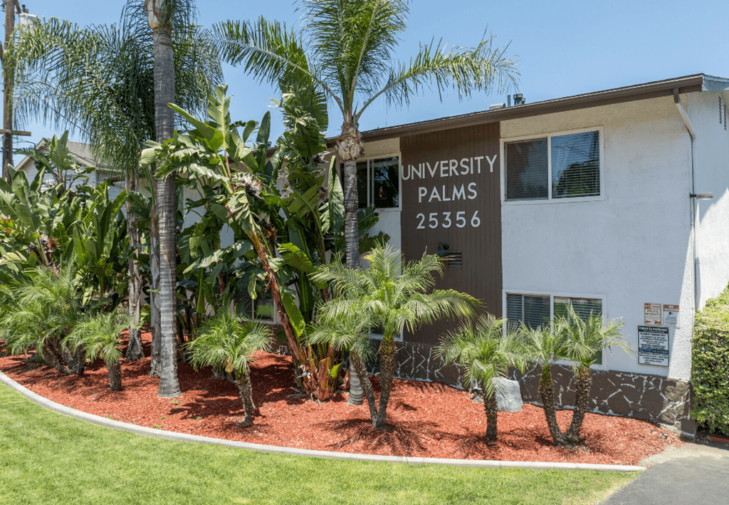 a building with palm trees in front of it