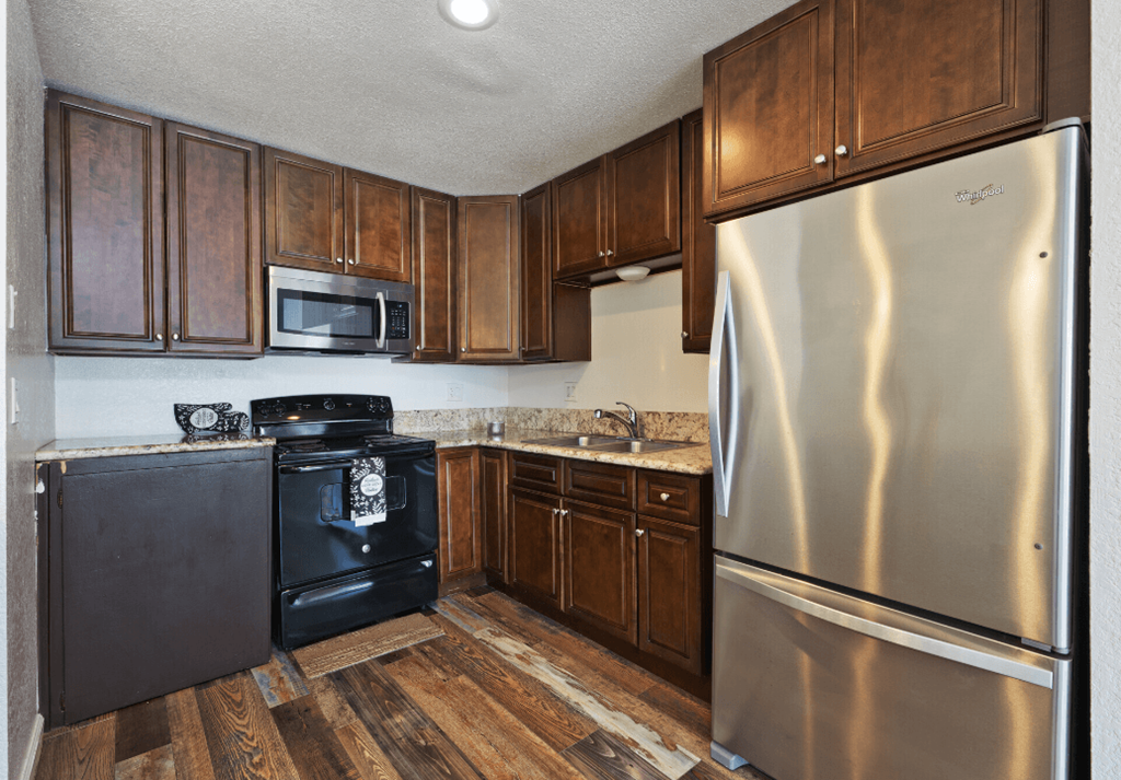 a kitchen with stainless steel appliances and wooden cabinets